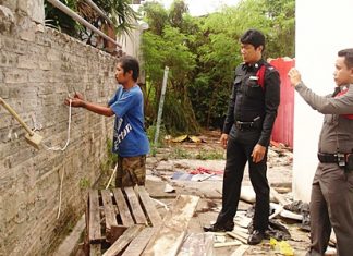 Wichian Dokmai shows police how he tried to steal electric wire from his neighbor.